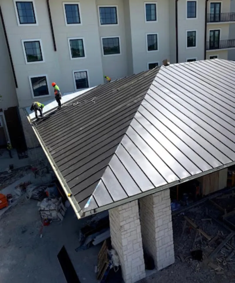 Crew installing standing seam metal roof panels on a commercial project in Silverdale